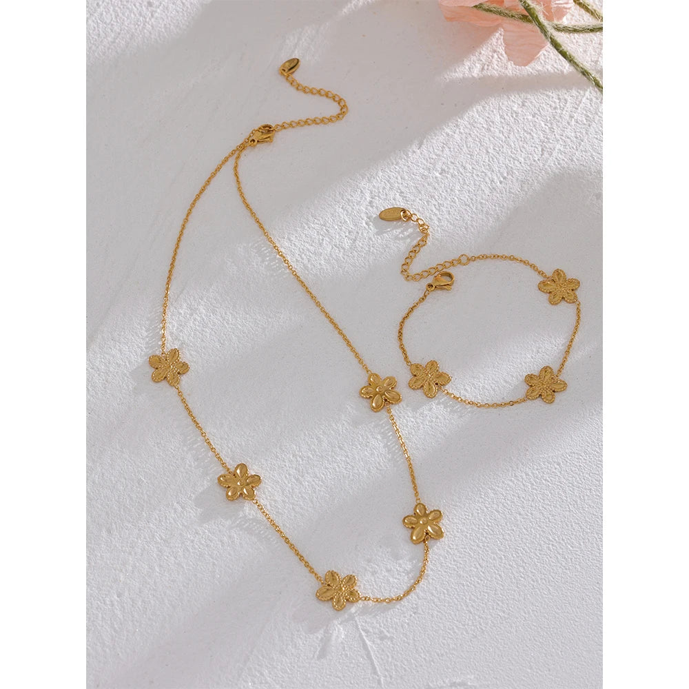 Gold chain bracelet and gold necklace necklace pairing with flower accent
