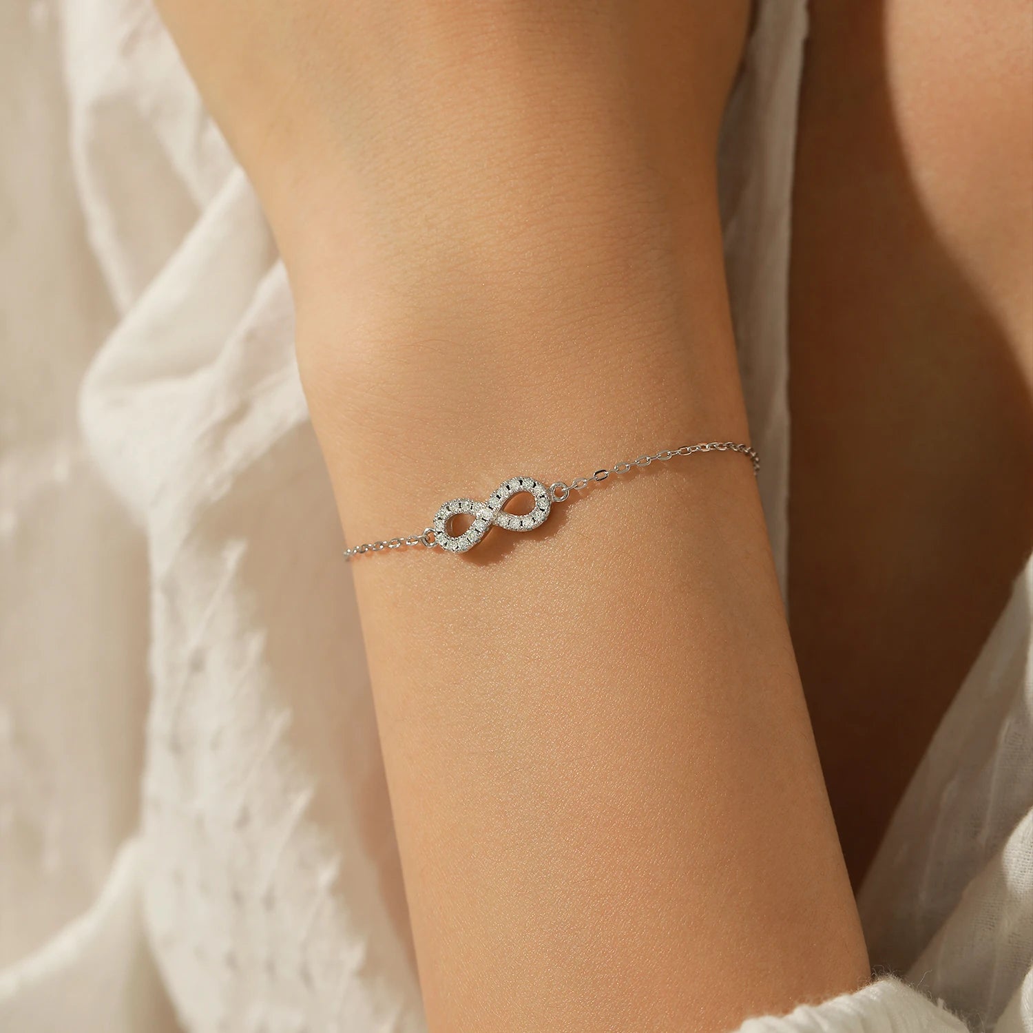 Close up of moissanite diamond infinity bracelet 925 silver