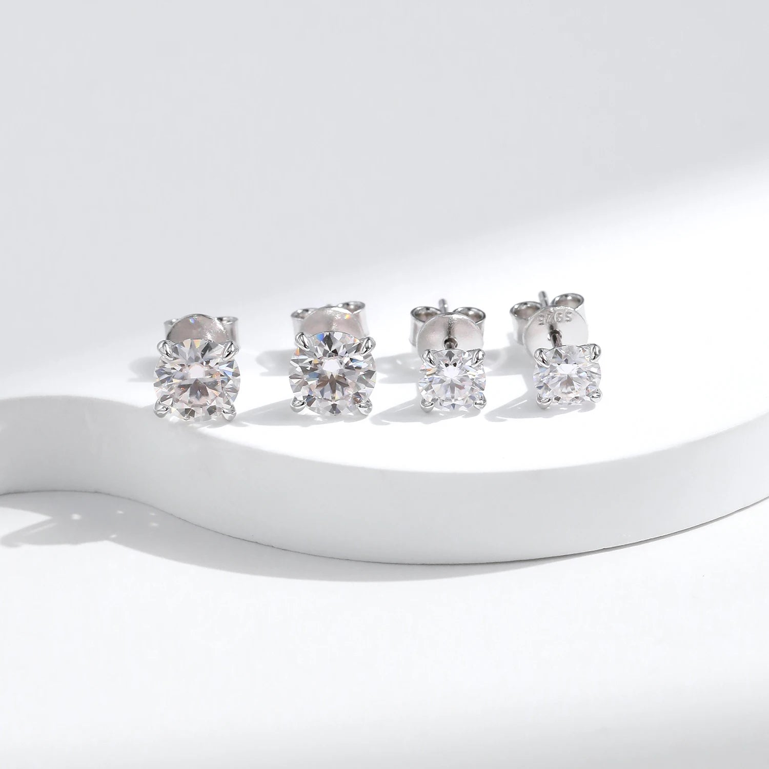 925 sterling silver studs shown beside matching jewelry sets