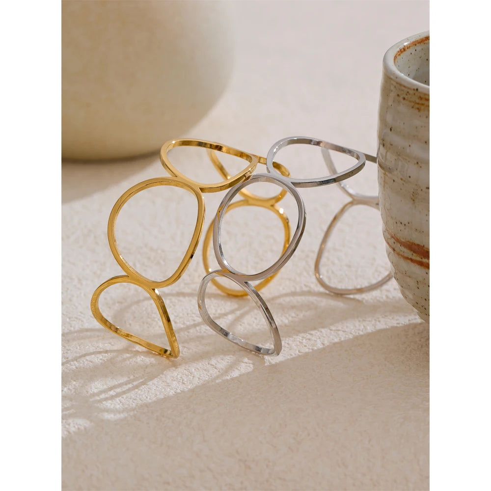 Minimal bangle bracelet finished in jewelry stainless steel with gold cuff accent