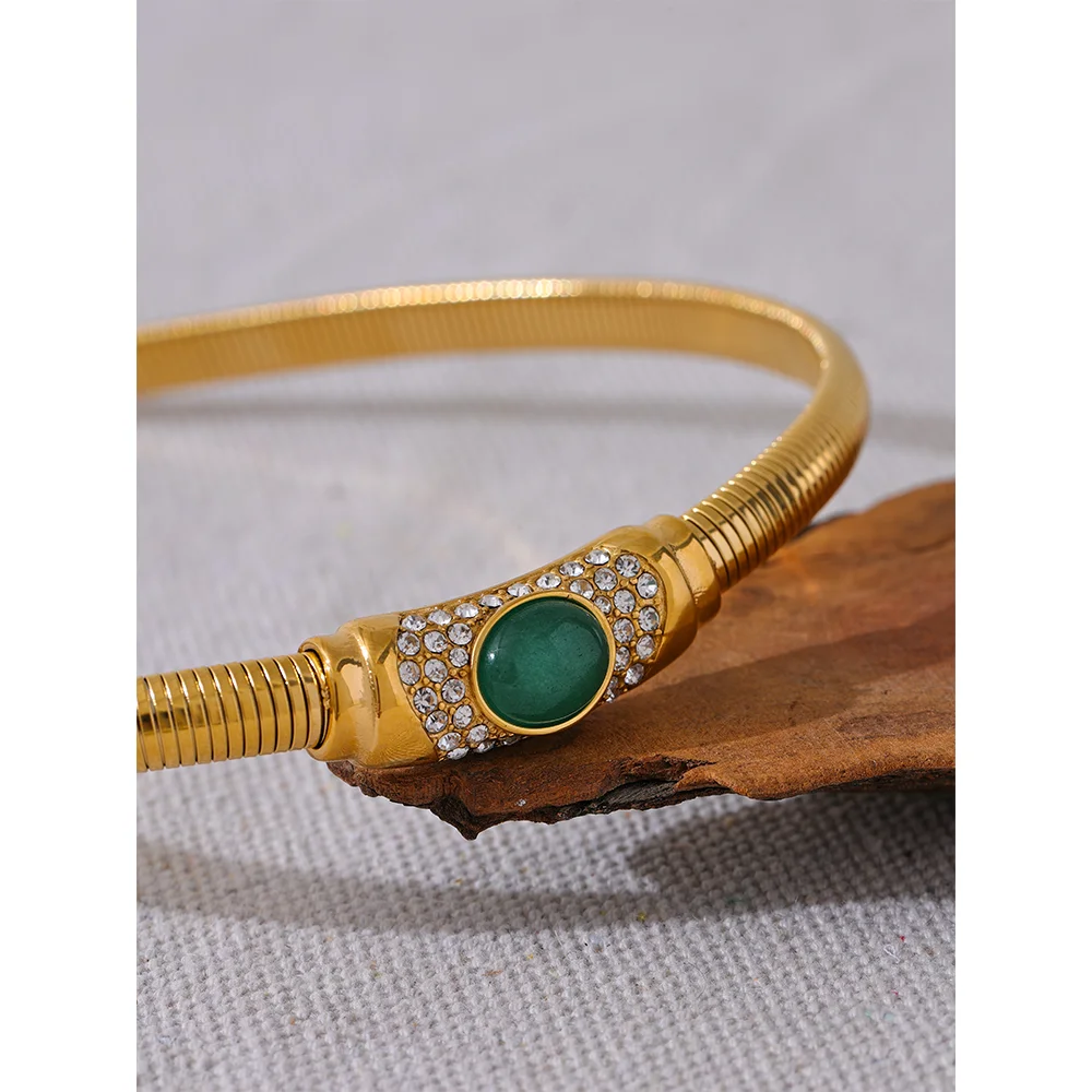 Stainless steel jewelry choker with gold finish and green zircon accent