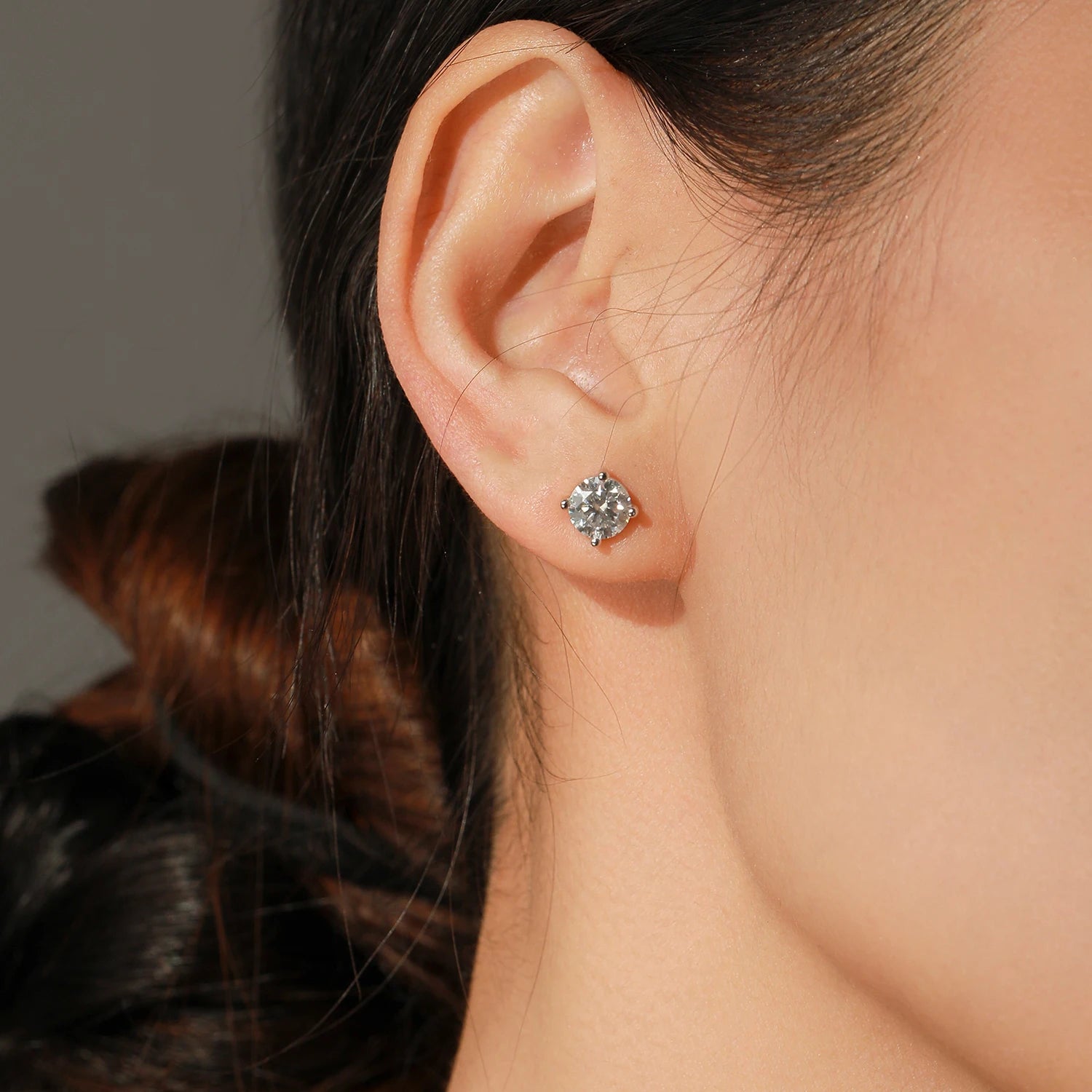 Necklace and earrings set featuring D Color moissanite with polished silver earrings on white background