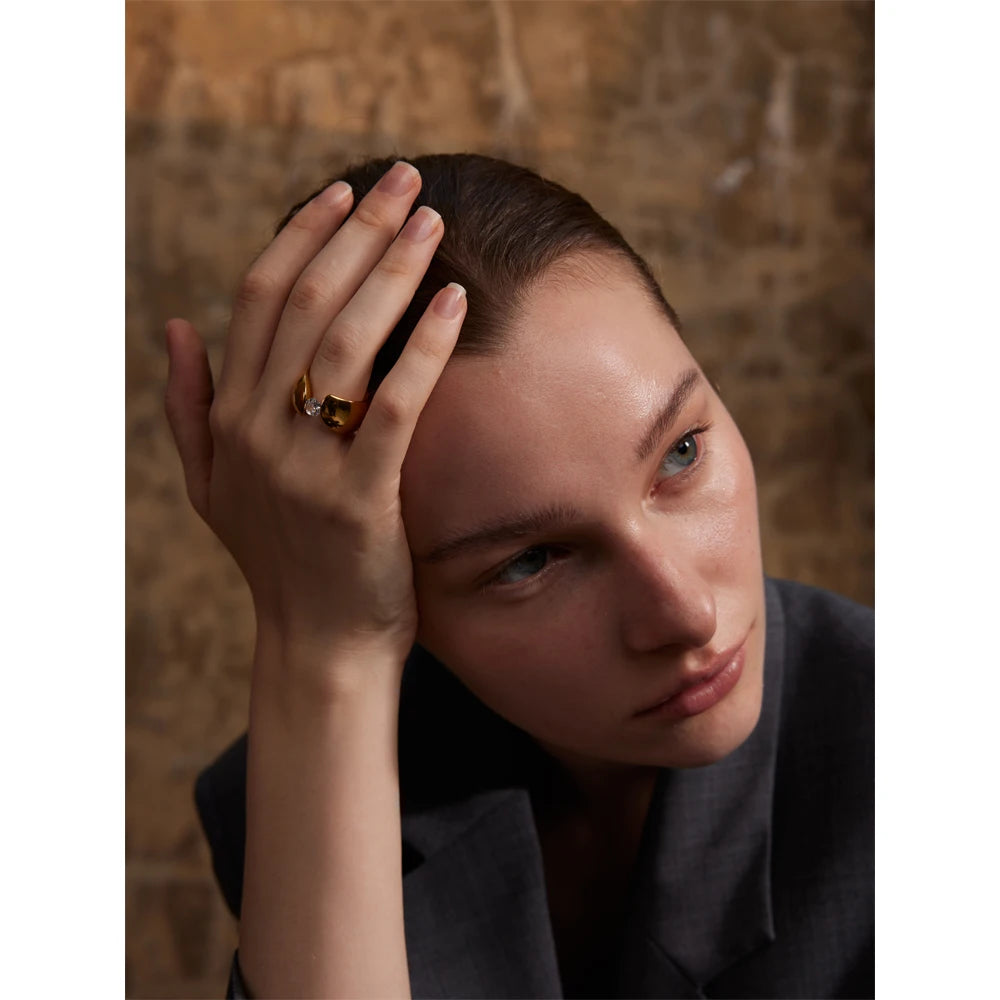 Gold plated band styled as a ring with gold and smooth shine