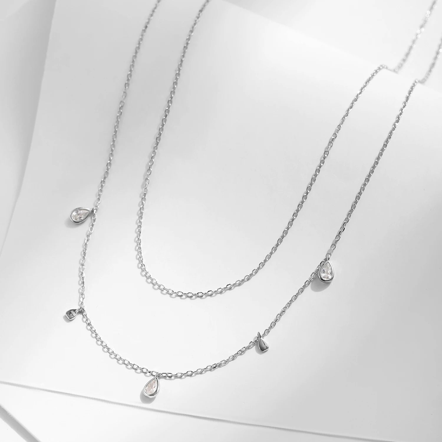 Sterling silver necklace featuring a pear shape moissanite chain drop