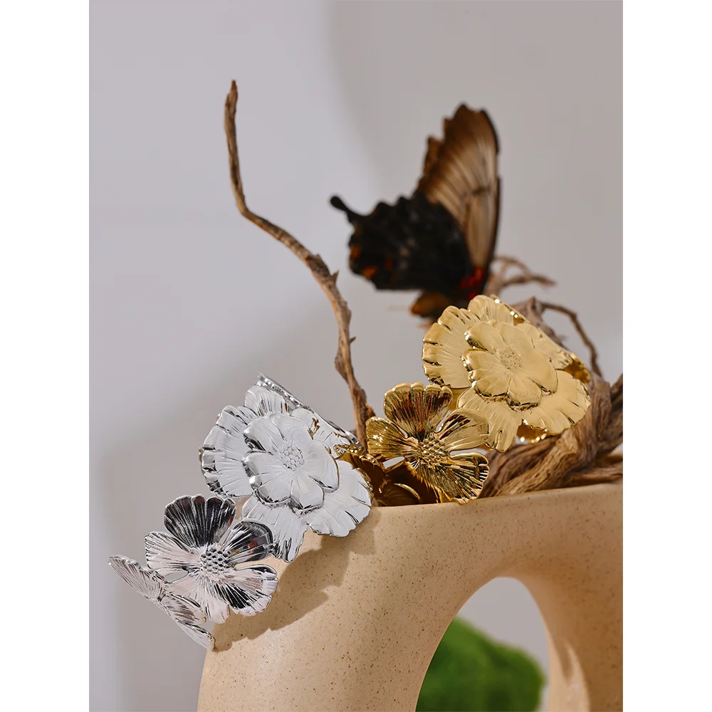 Open bangle bracelet showing a bracelet with gold floral accent