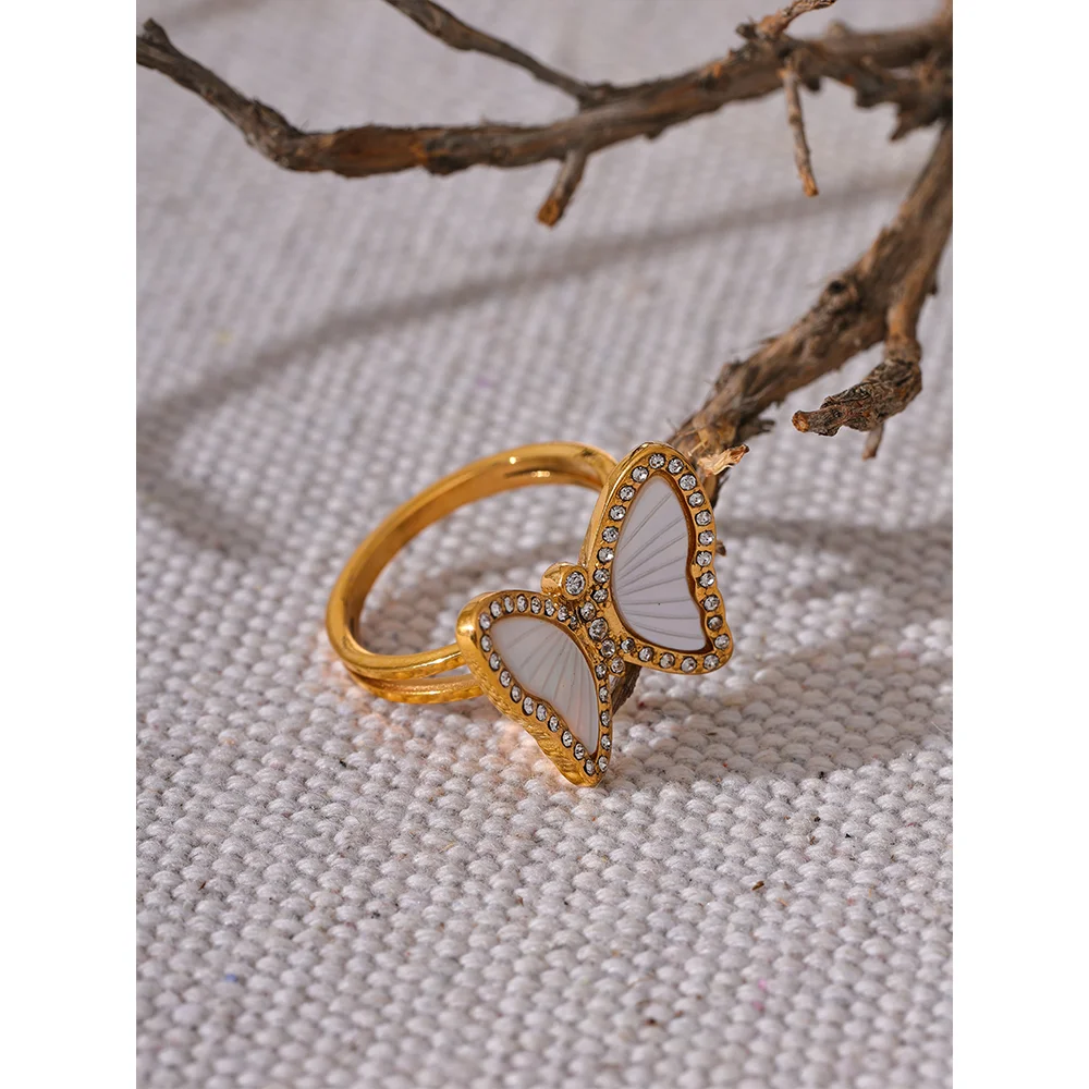 Elegant cubic zirconia ring with ring with gold detail and butterfly ring charm