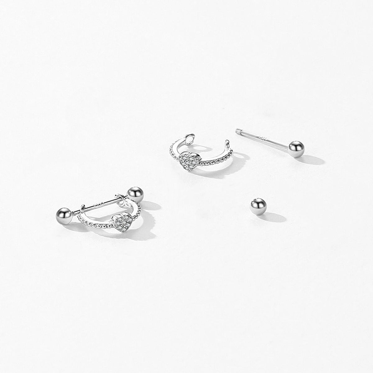 Close view of heart earrings on a silver hoop in sterling silver