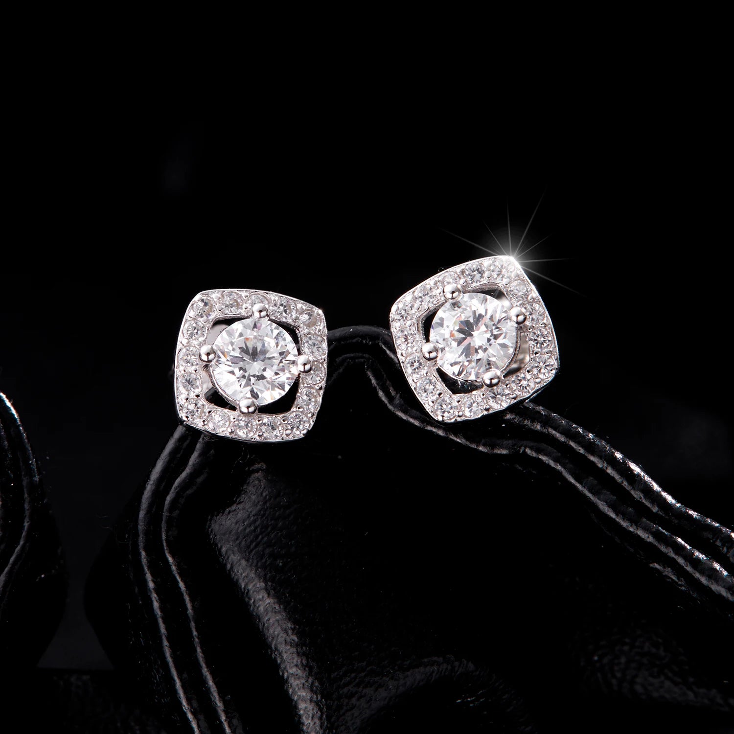 Pair of silver stud earrings showing sugar cube design and clear zirconia facets