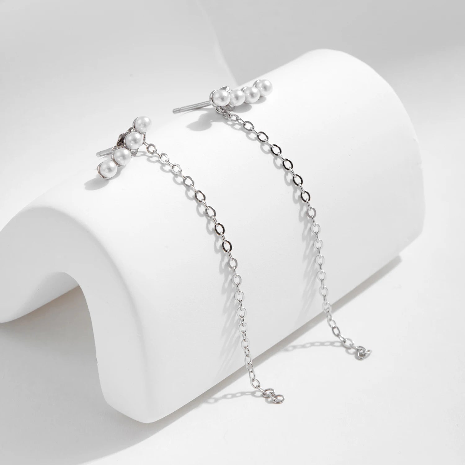 Pair of pearl drop earrings with sterling silver geometric frames