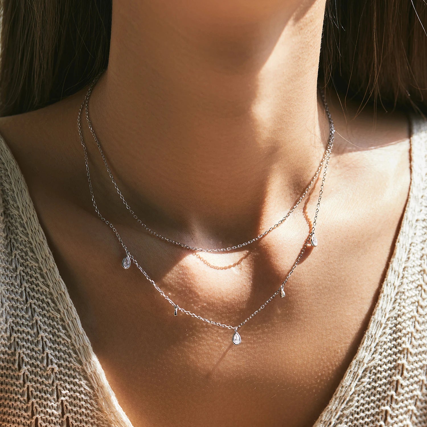 Pendant necklace with moissanite jewelry on a polished silver chain