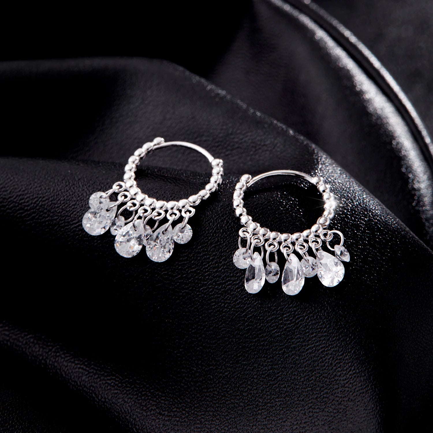Sterling silver hoop earrings photographed to highlight zircon sparkle and polish