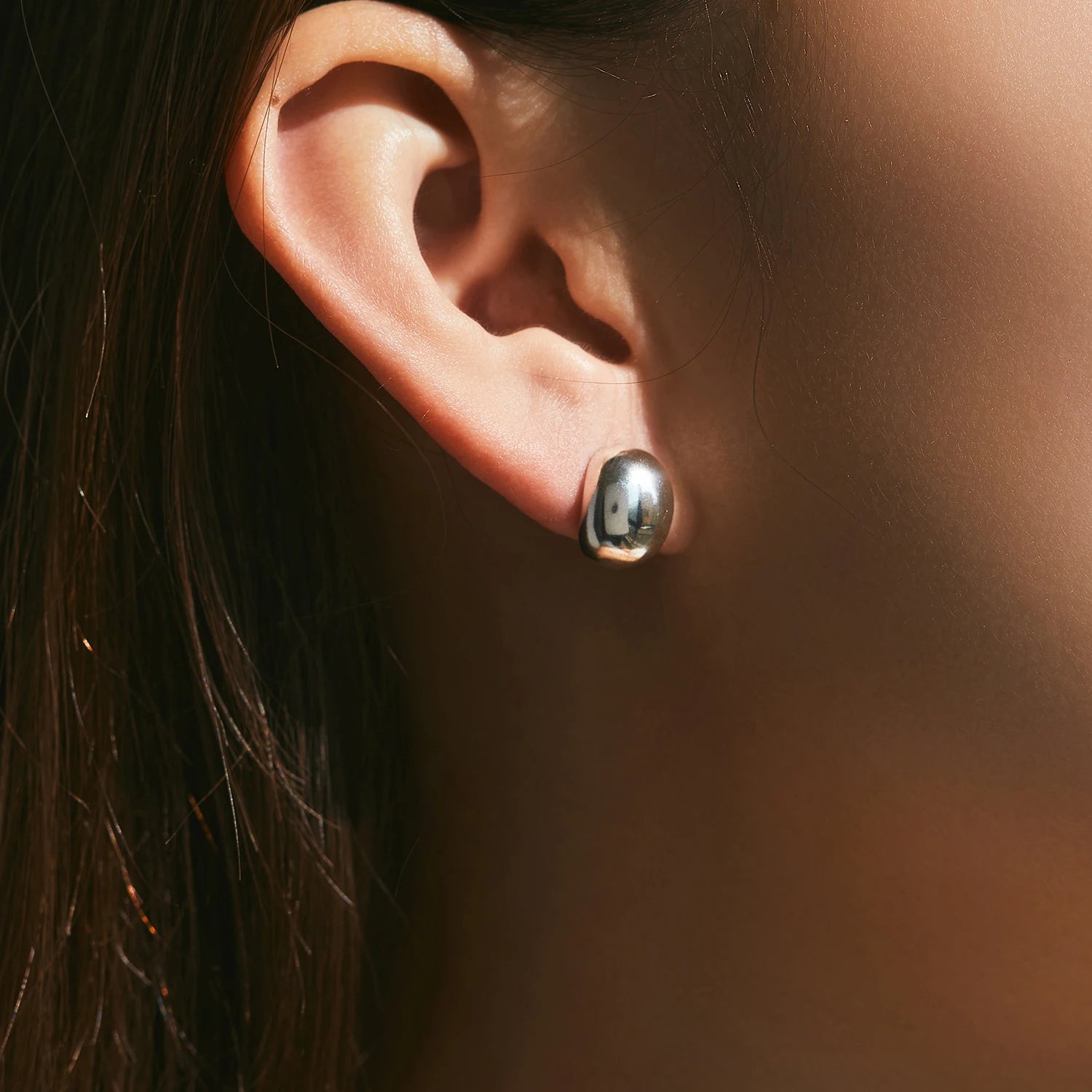 Silver stud earrings with polished mirror finish in silver color