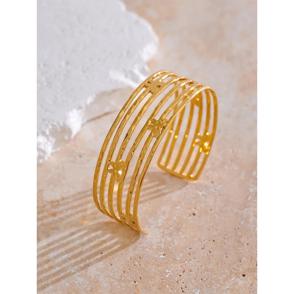 Close view of a gold cuff bracelet styled as a butterfly bracelet