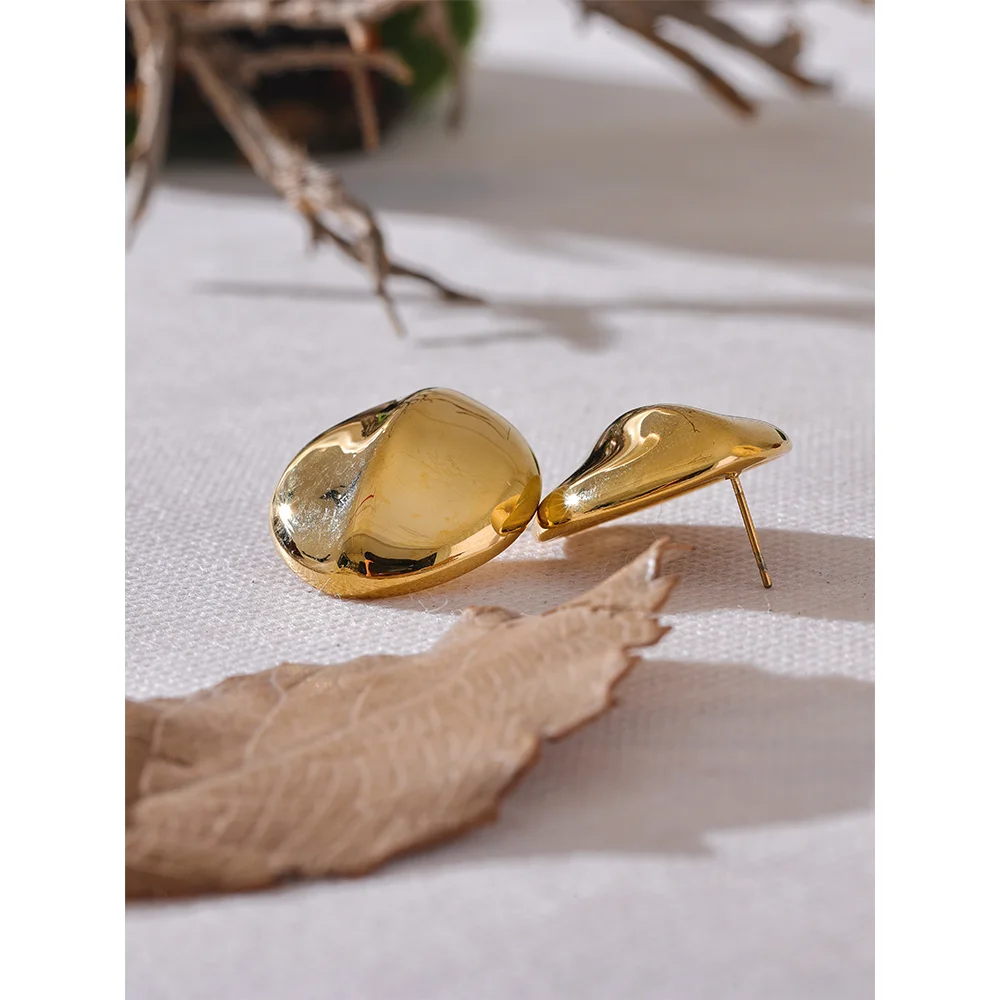 Sleek ear rings shown with earrings and gold layers