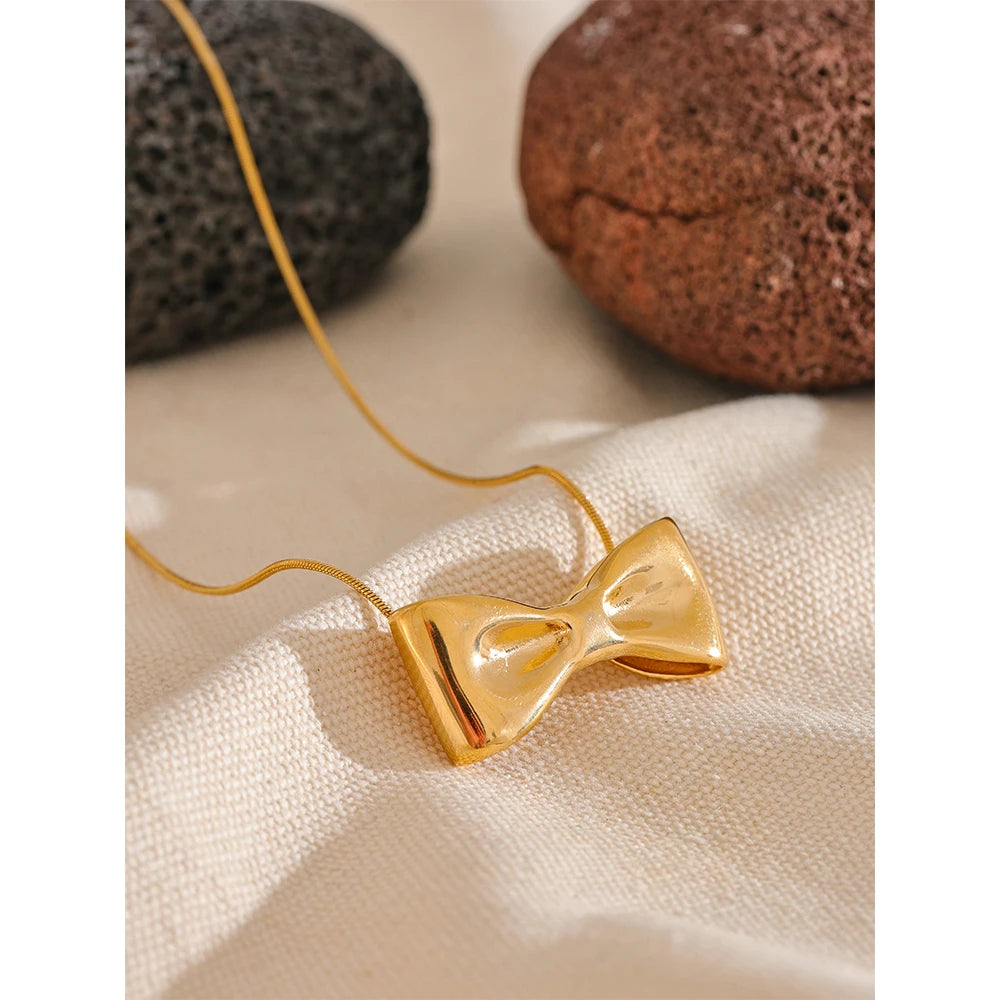 Layered style bow knot pendant paired with matching chain