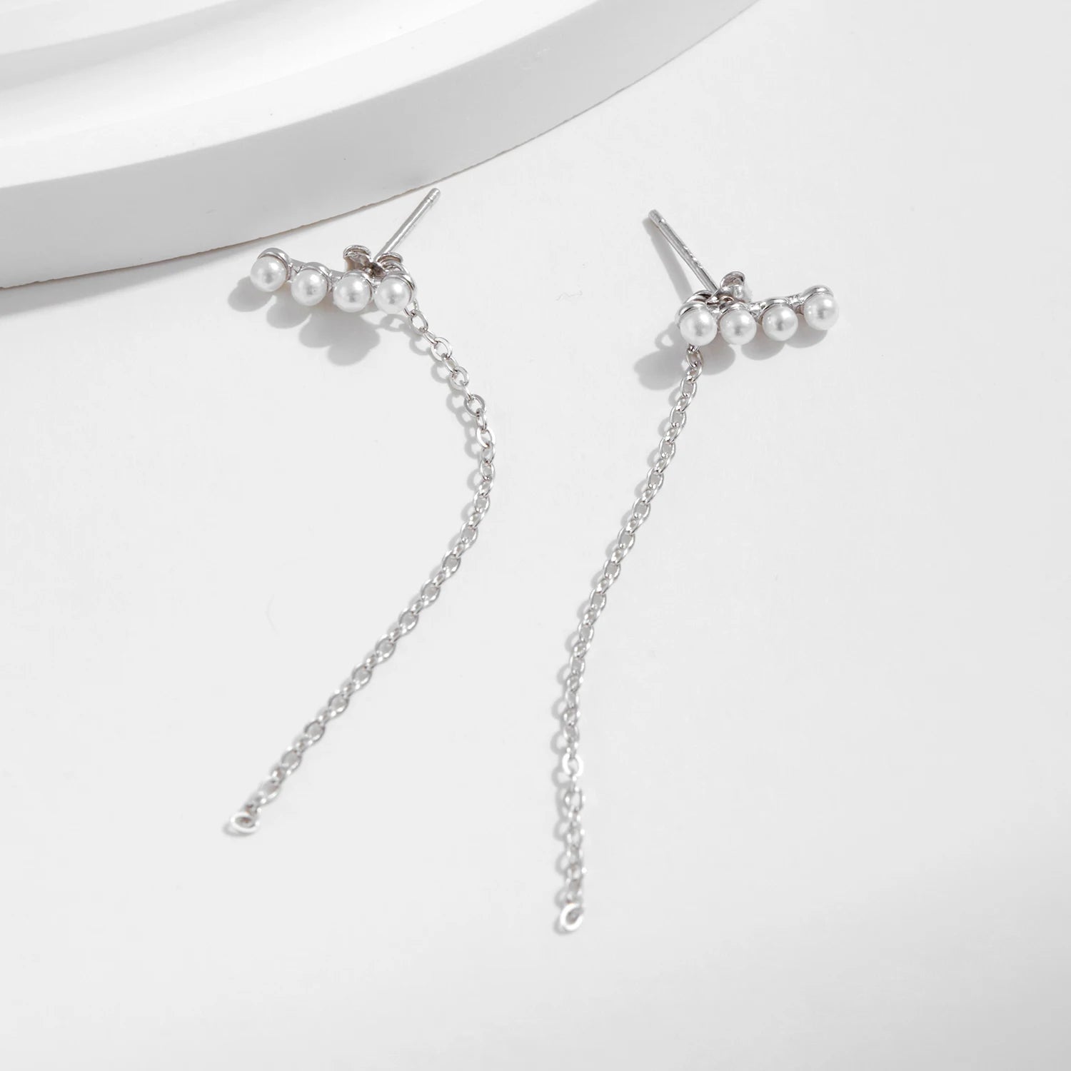 Silver earrings featuring pearl drop design and crystal accents