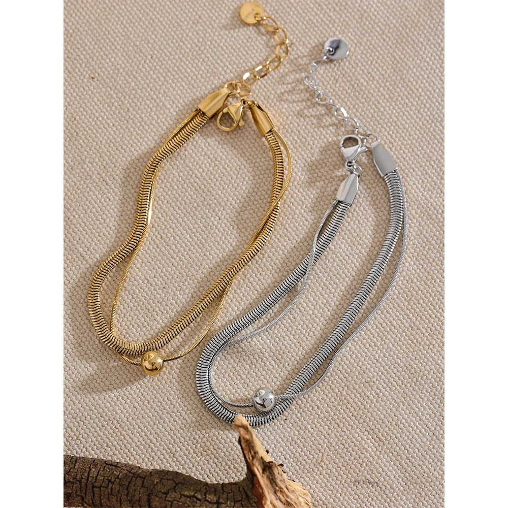 Minimal bracelet chain next to a bright gold chain