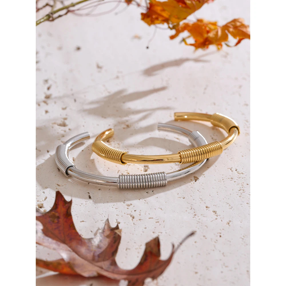 Minimal studio shot of gold colored bangle bracelet in jewelry waterproof polish