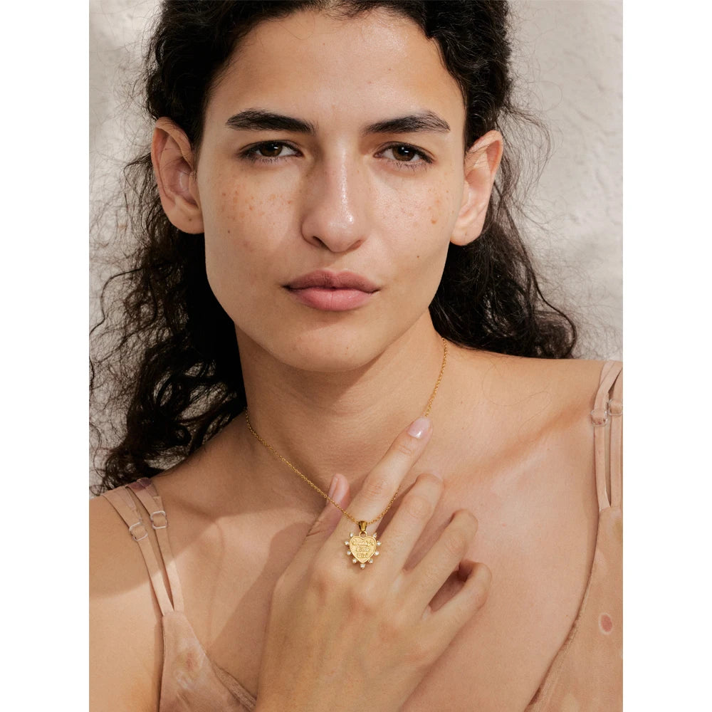 Heart earrings plated in gold shown with matching necklace