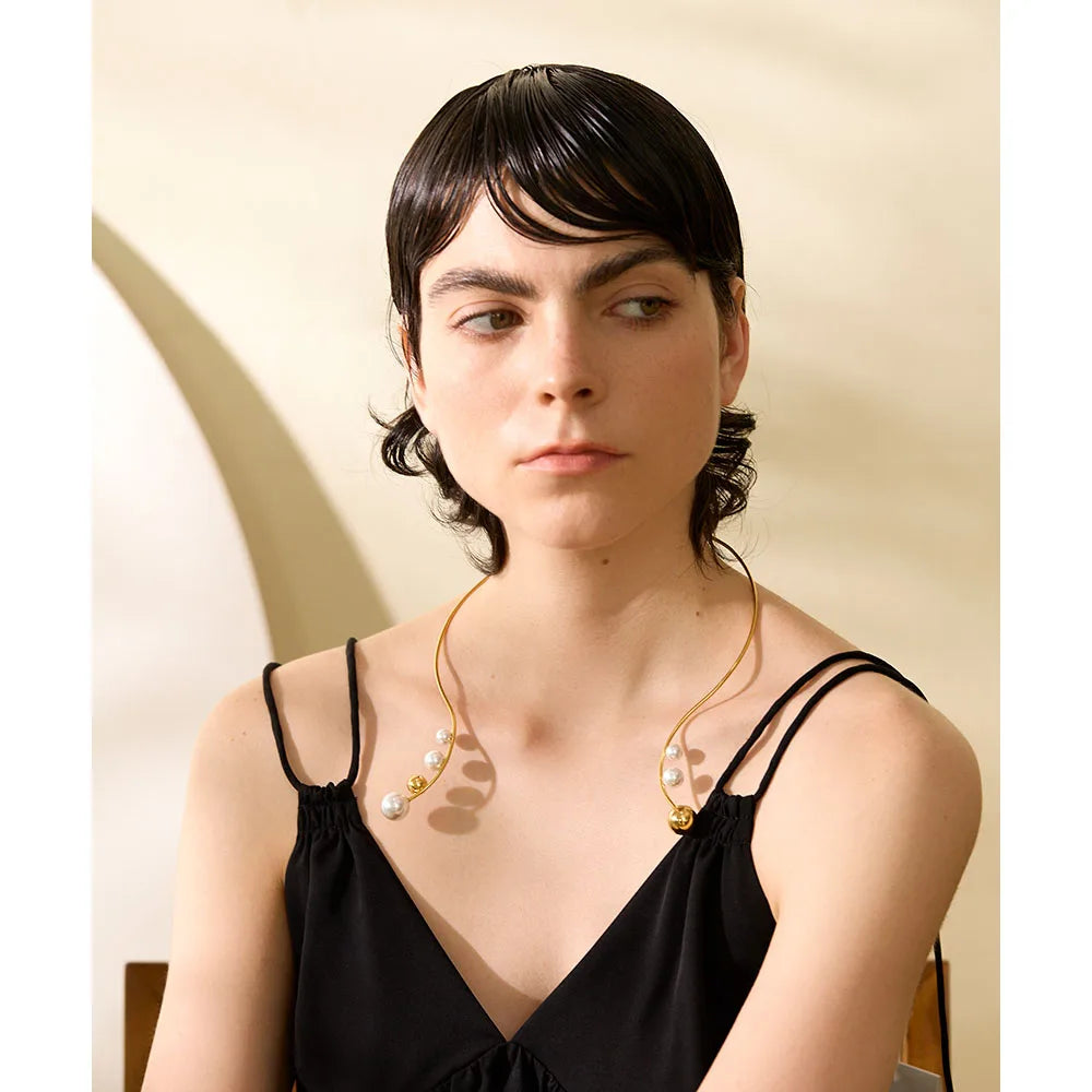 Necklace with gold and necklace with pearls on a torques band