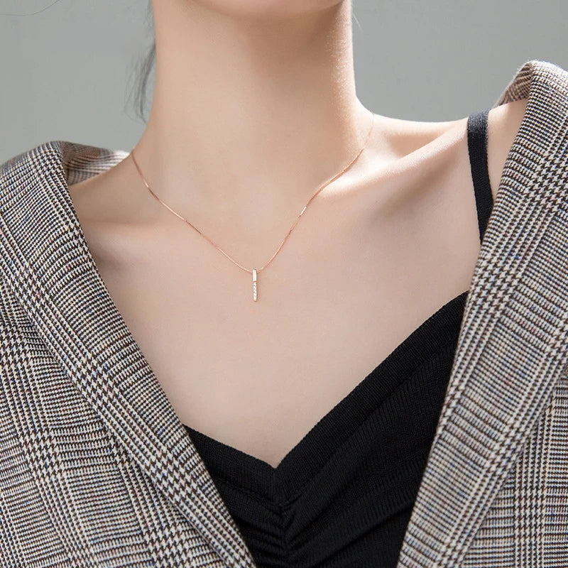 Long necklace look with a sleek pendant necklace and silver chain