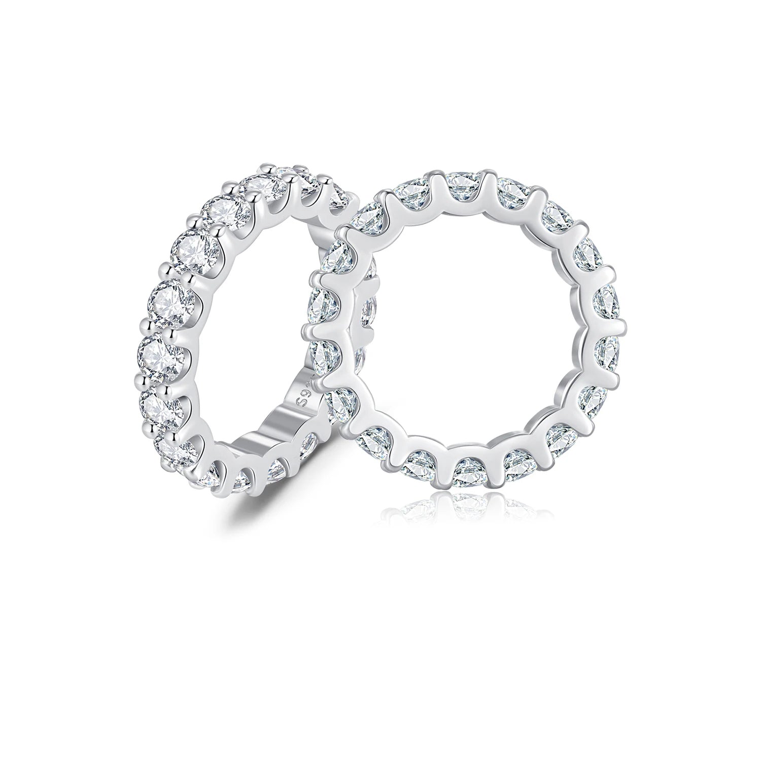 Silver ring with clear gemstones on a white background