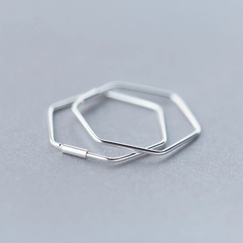 Front view of silver hoop showing modern geometric silhouette and polished finish