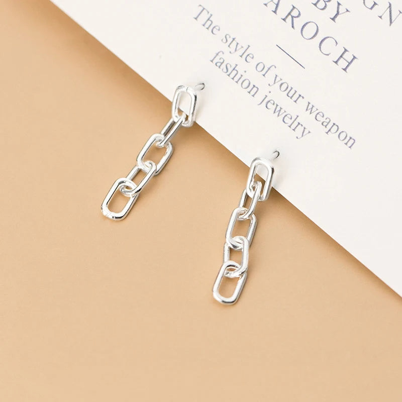 Dangle earrings pairing beautifully with a silver necklace stack