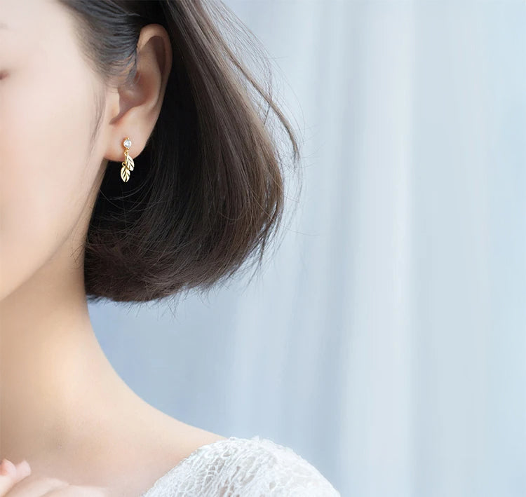Close up of leaf earrings showing CZ stones and delicate swing movement