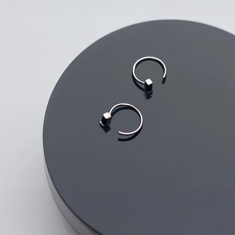 Elegant obsidian stone hoop earrings displayed against neutral background