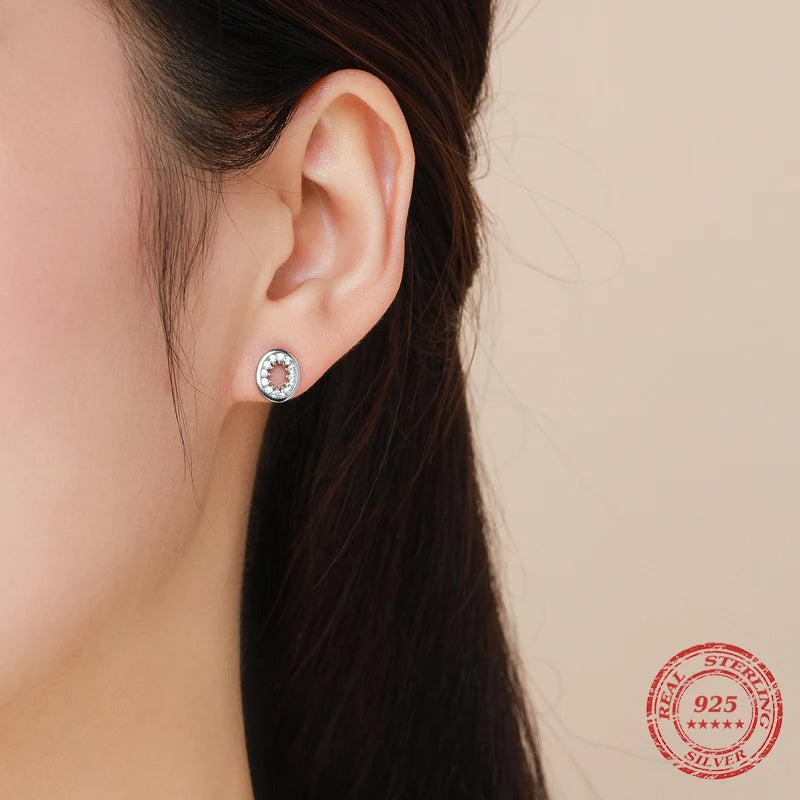 Close up of CZ stud earrings oval design in polished silver color