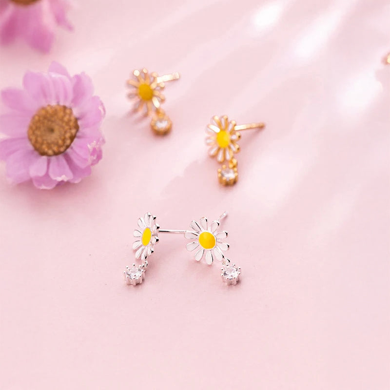 Sterling silver earrings with daisy flower detail styled as silver stud earrings