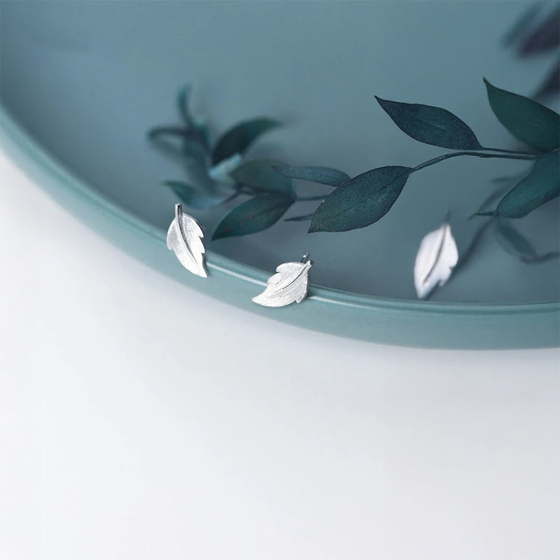 Minimal stud earrings for women featuring subtle leaf design