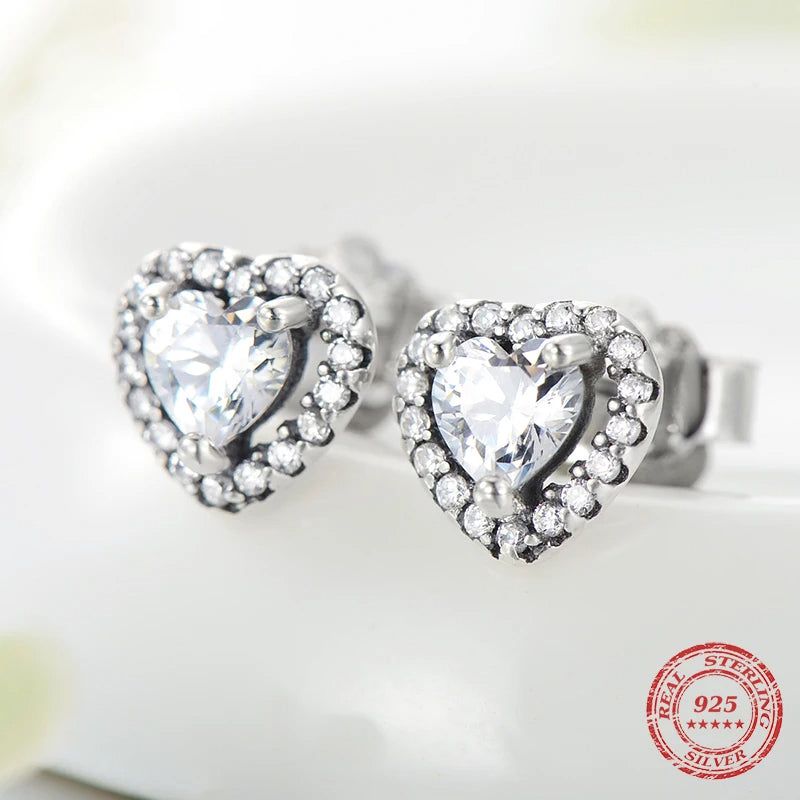 Close view of stud earrings showing a delicate cz heart center