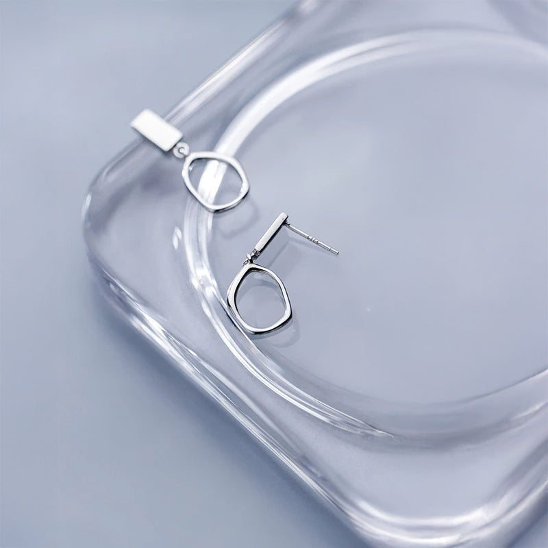 Silver color oval earrings offering smooth, modern lines