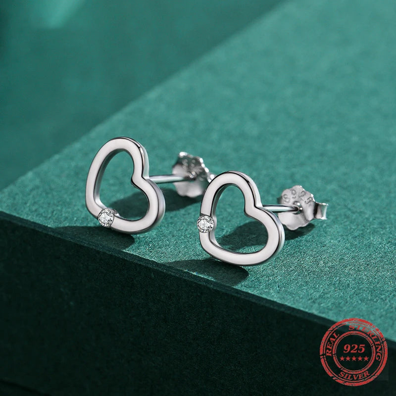 Classic stud earrings in a gold heart style with cubic zirconia shine