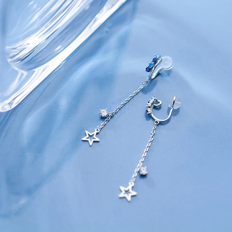 Detail of earring earrings chain and tassel showing crystal accents and clip mechanism
