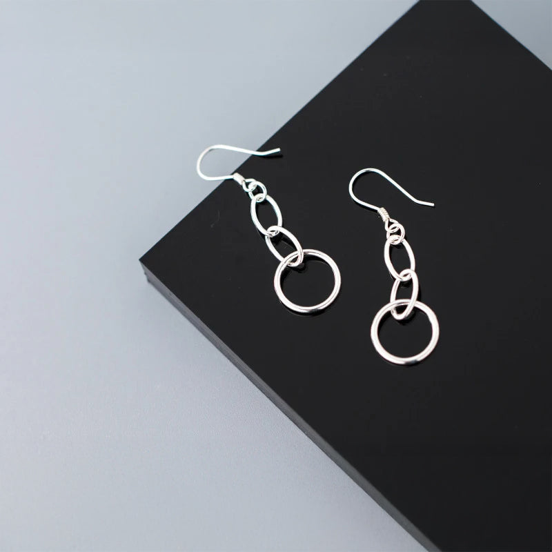 Close view of sterling silver dangle earrings in polished finish