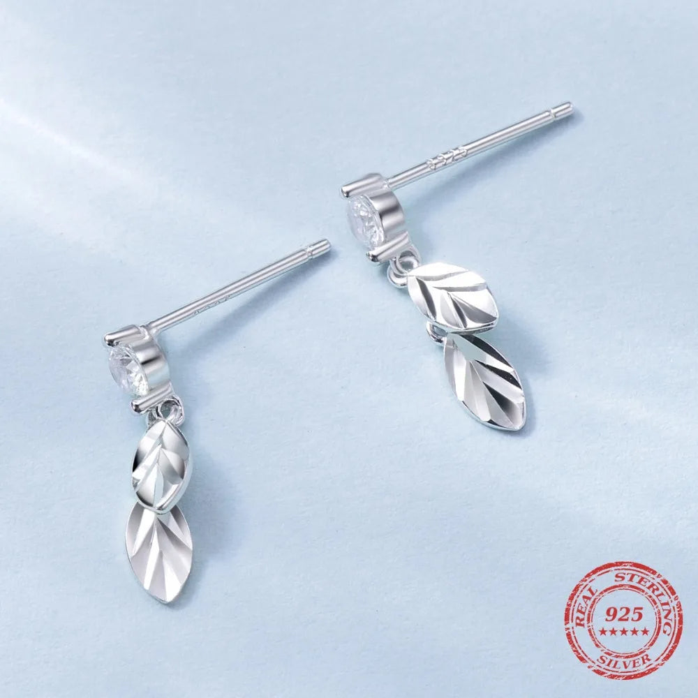 Elegant cubic zirconia leaf earrings swinging gently as ear rings