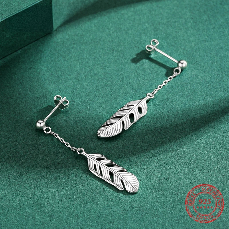 Silver color long earrings with leaf earrings detail in a drop earrings style