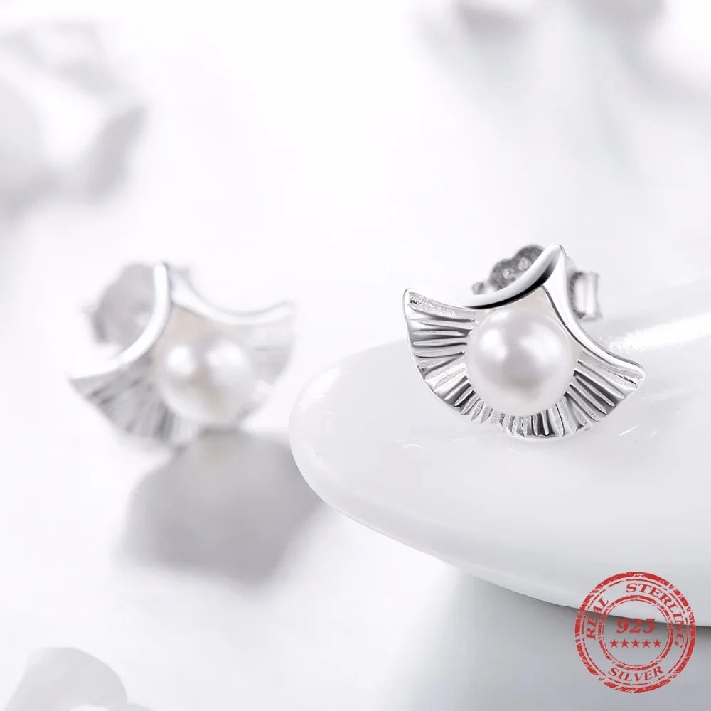 Delicate pearl earrings stud style with smooth silver color finish