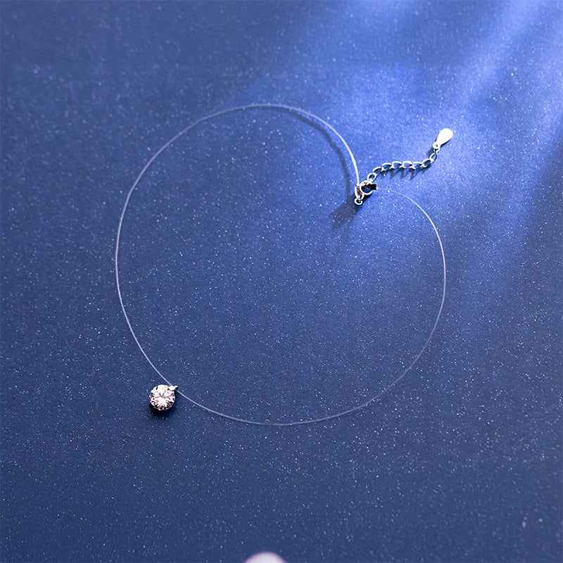 Minimal choker necklace paired with a delicate charm necklace