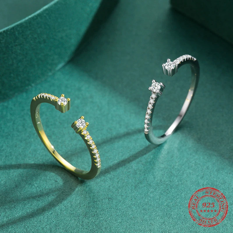 CZ ring presenting bright clarity beside gold rings gold stacks