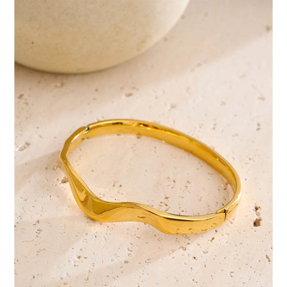 Polished gold plated bangle reflecting modern golden jewelry
