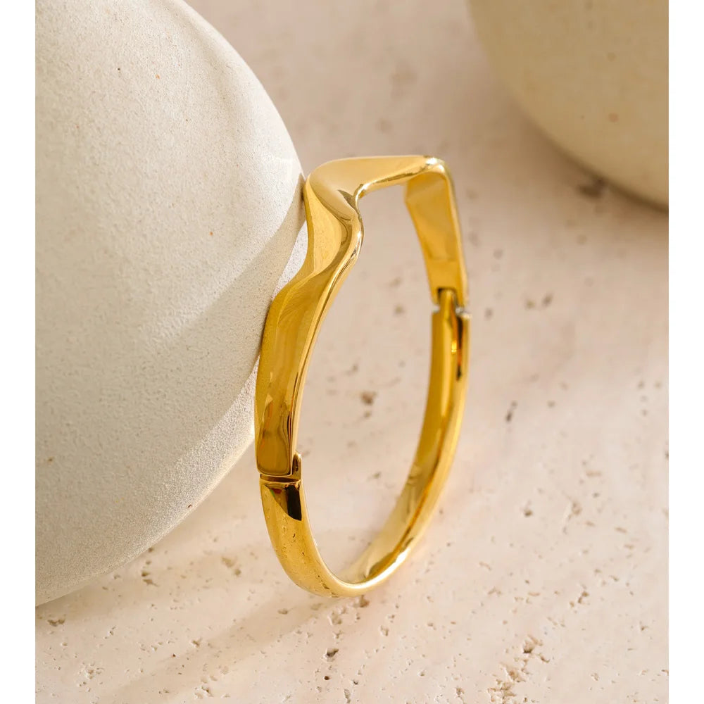 Gold bangle gold bracelet featuring smooth metal lines