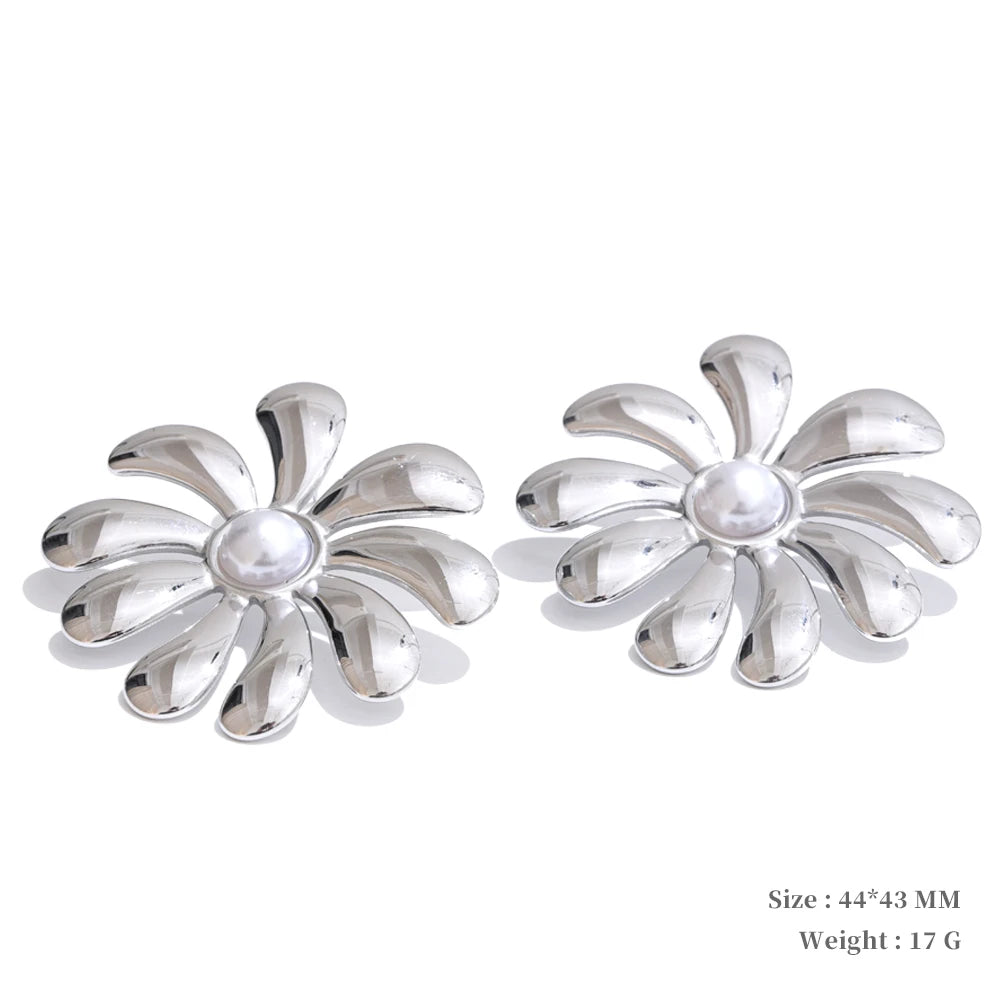 Jewelry gold jewelry presentation of flower earrings beside a gold necklace necklace