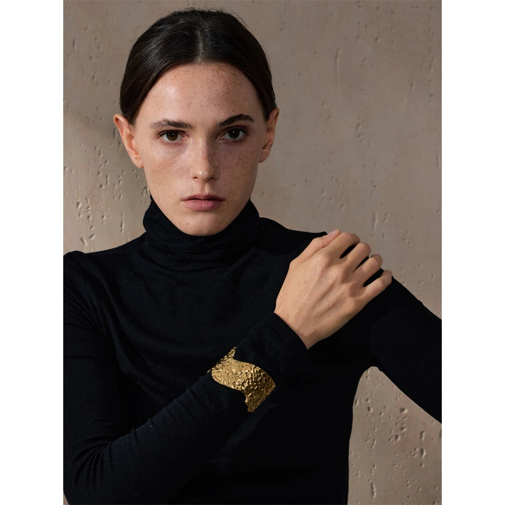 Close up of hammered pattern gold bracelet cuff