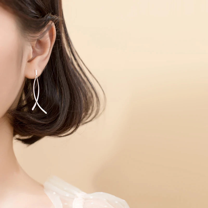 Ear rings close up showing refined crossover earrings lines