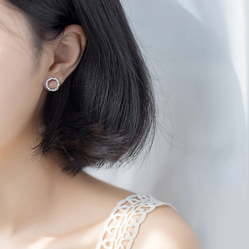 Silver earrings with cz studs in a clean geometric form and rose gold hint