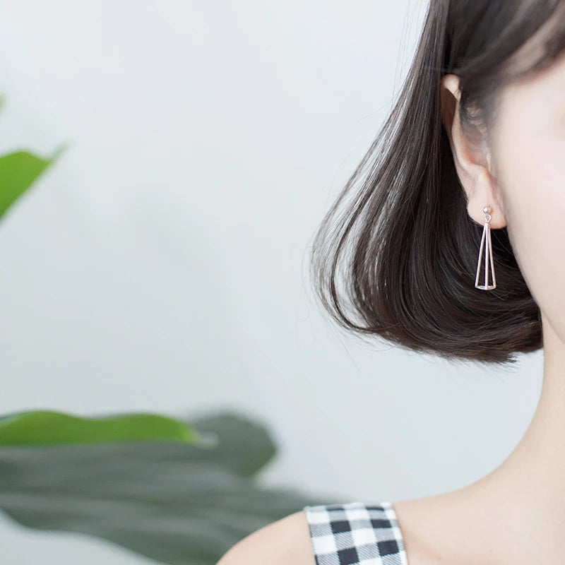 Sterling silver earrings showcasing a sleek 3D triangle and silver color shine